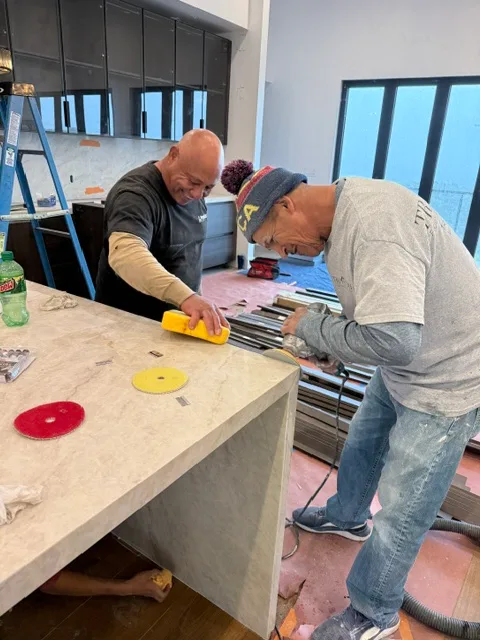 Pros fabricating and polishing a stone kitchen countertop