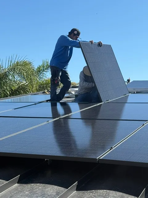 Crew setting rooftop solar panels